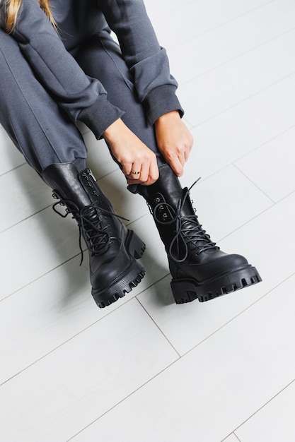 Black leather boots on women's legs New collection of warm winter women's shoes