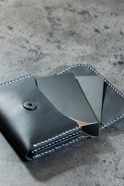 Black leather cardholder on a gray background Handmade leather products