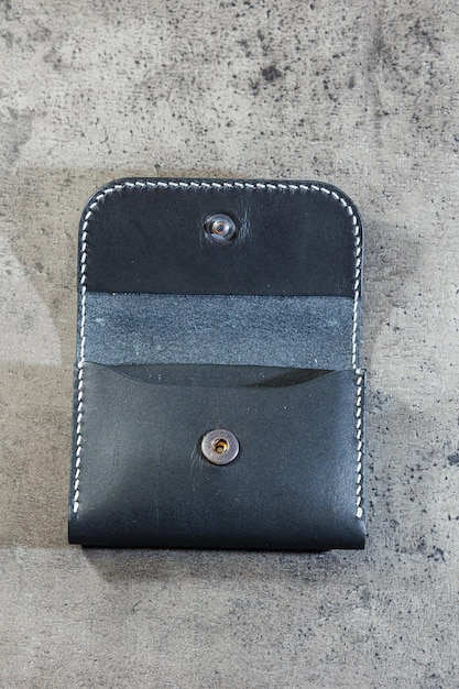 Black leather cardholder on a gray background Handmade leather products