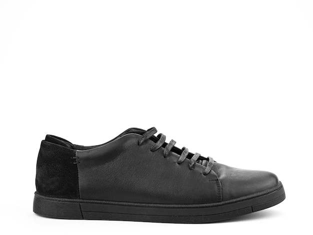 Black leather classic sneakers with laces Casual men's style Black rubber soles Isolated closeup on white background Right side view