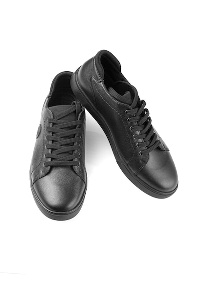 Black leather sneakers on a white background