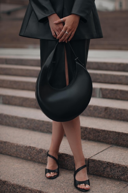 Black leather trendy cloth handbag and silver accessories fancy outfit female fashion accessories