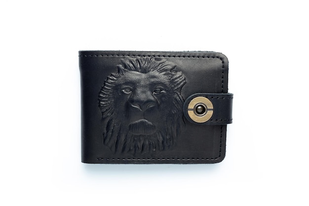 Black leather wallet on a button on a white background lion print Top view