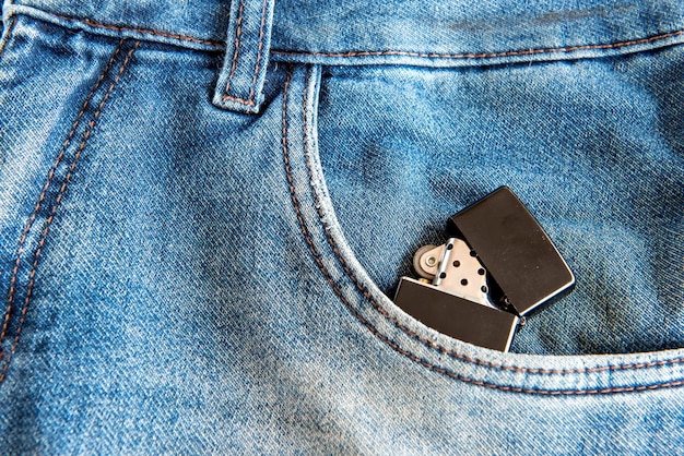 Black lighter in jeans pocket.