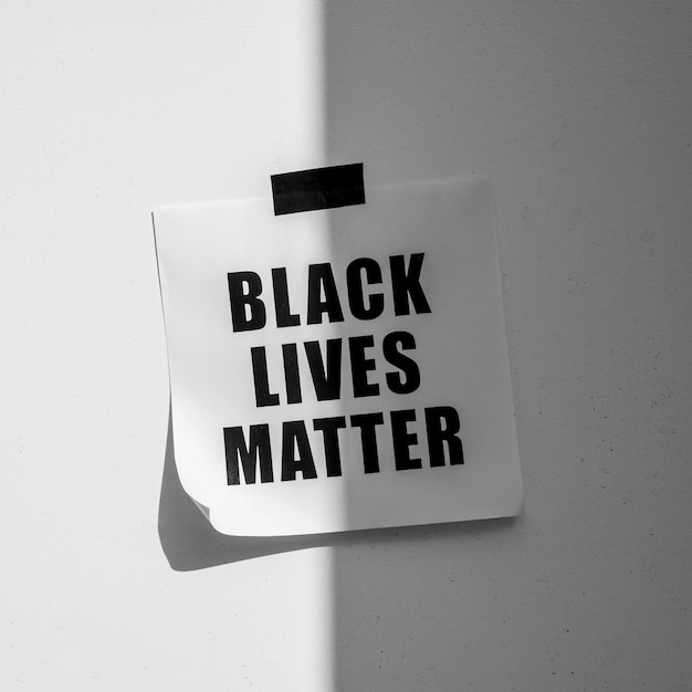 Black lives matter movement message on wall with shadow