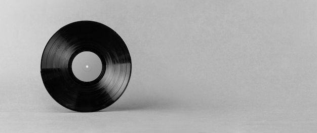 Black LP vinyl record isolated on abstract gray background