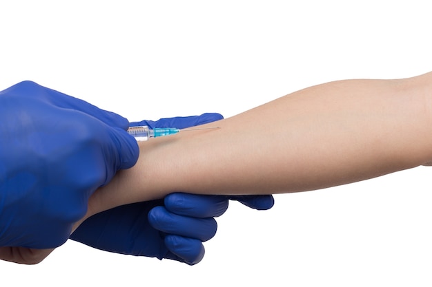 Black male hand in blue gloves holding a plastic syring with liquid for injection isolated on white background. Health care, treatment concept