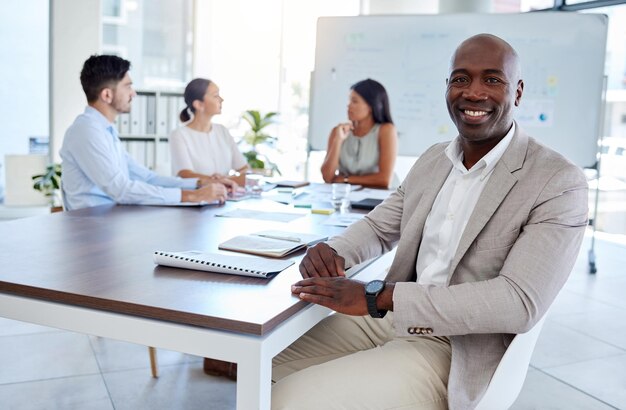 Black man business meeting and portrait in office startup and teamwork planning in corporate company Happy smile and vision of executive businessman at table with motivation goal and innovation