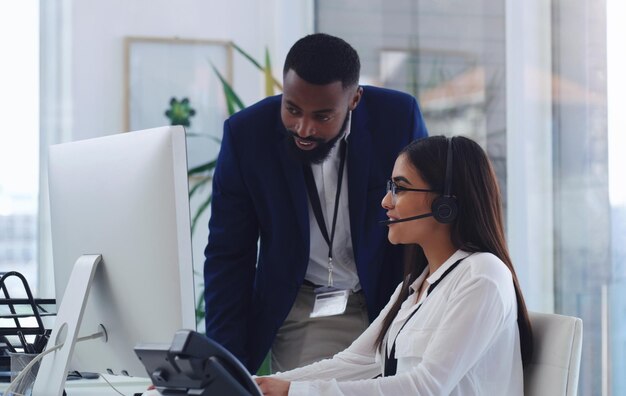 black man call center and woman with coaching by computer office and learning in tech support african male crm mentor and teaching for telemarketing training and customer service at help desk
