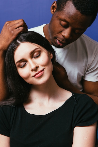 Black man caress white woman hair, closeup