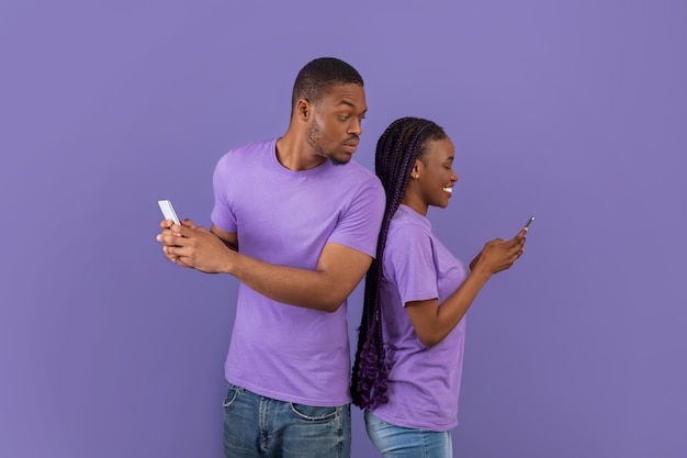 Black man checking his girlfriend mobile phone