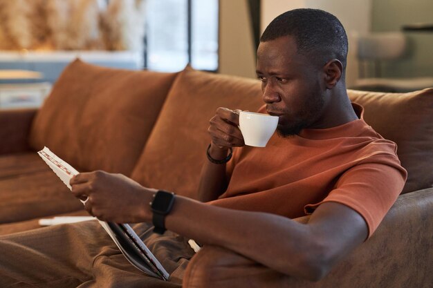 Black man enjoying cup of coffee in cafe