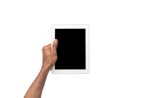 Black man holding digital tablet isolated on white background. African-american man with gadget with blank screen, copy space for advertisement