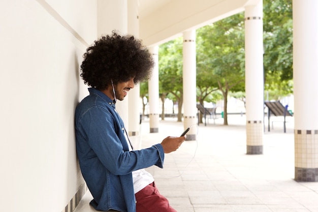 Black man listening to music on mobile phone