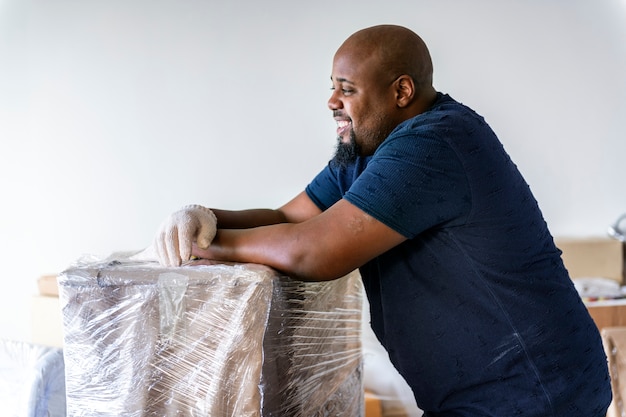 Black man moving furniture