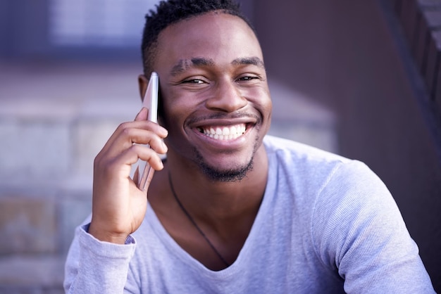 Black man phone call and portrait in city for talking networking and happiness on stairs Male college student mobile and listen to joke for communication laugh and relax with technology