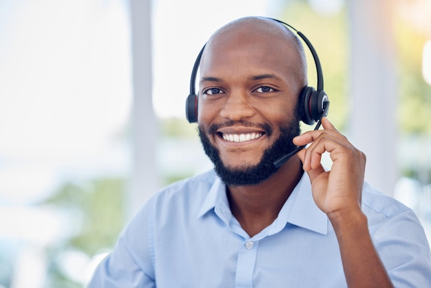 Black man portrait and callcenter with phone call and contact us communication with headset and CRM Male consultant with smile customer service or telemarketing with tech support and help desk