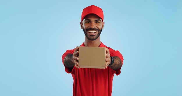 Black man in portrait with delivery box and ecommerce distribution with supplier and service on blue background giving package supply chain and logistics worker for shipping and courier in studio