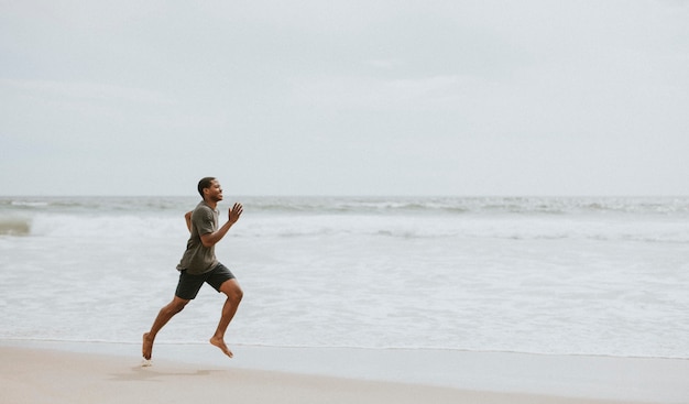 Black man running on the beach