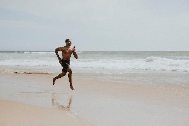 Black man running on the beach