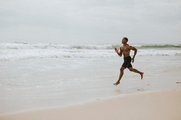 Black man running on the beach