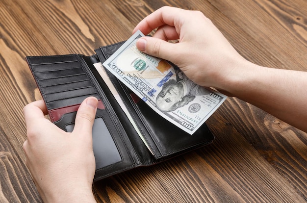 Black man's wallet in man hands