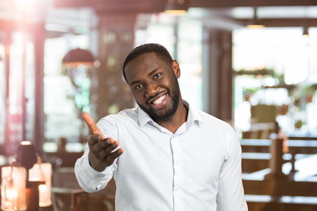 Photo black man in shirt pointing hand straight. portrait of handsome man gesticulating with hand.