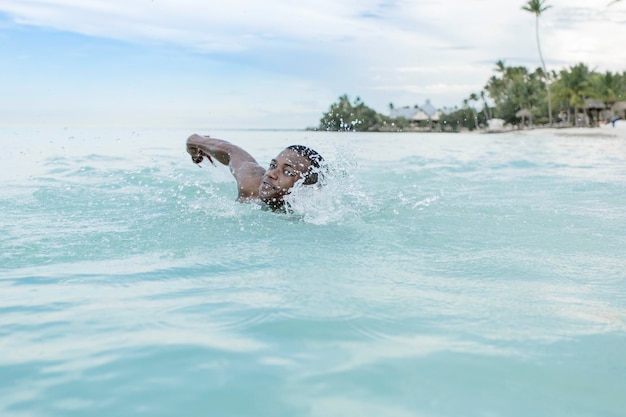 Black man swimming in sea