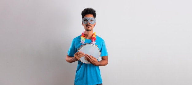 Black Man With Carnival Costume Holding a Tambourine Isolated on White