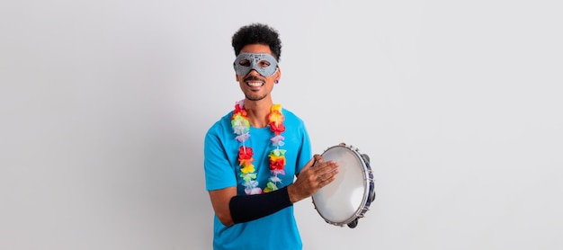 Photo black man with carnival costume holding a tambourine isolated on white