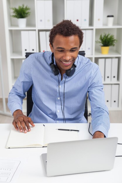 Black man with laptop at work