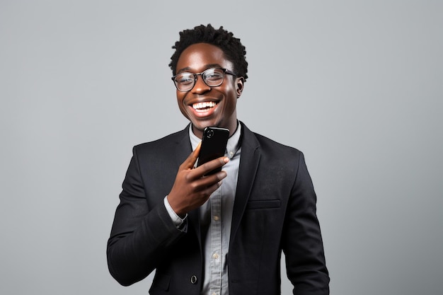 Black man with phone on studio background
