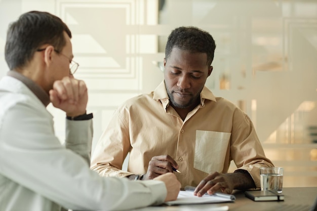 Black man working on project with colleague