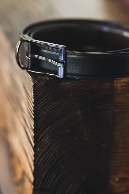 Black men\'s belt on a wooden stand