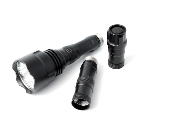 A black metal coated flashlight isolated on white