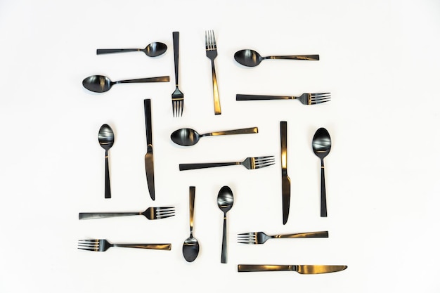 Black metal forks and spoons on a white background mexico