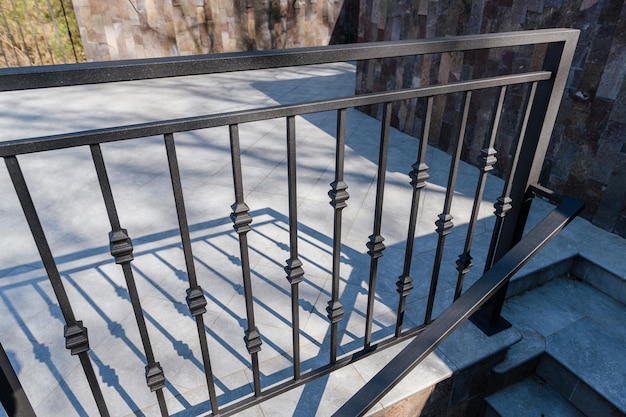 Black metal railings with wrought iron elements