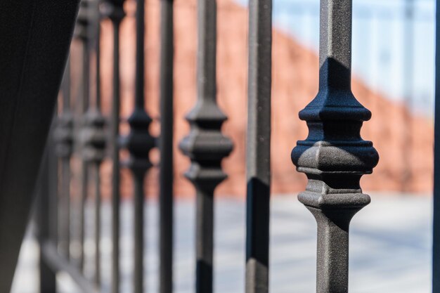 Black metal railings with wrought iron inserts