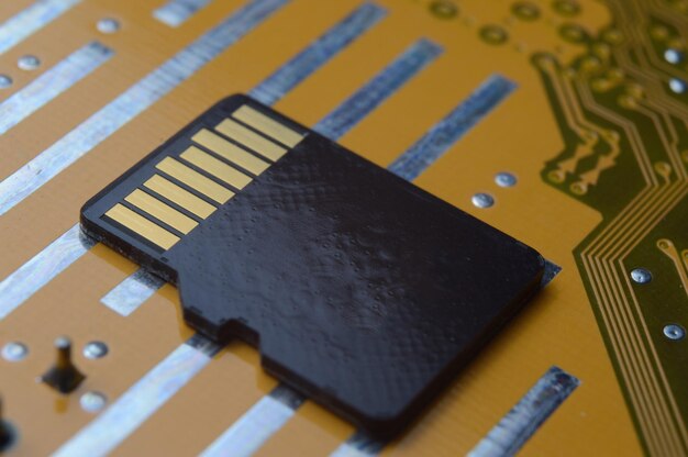 The black micro sd card lies on the microcircuit. close-up.