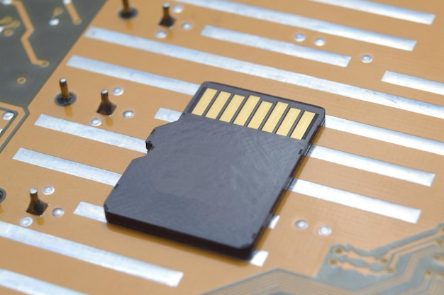 The black micro sd card lies on the microcircuit. close-up.