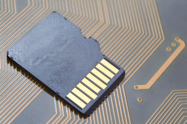 the black micro sd card lies on the microcircuit. close-up.