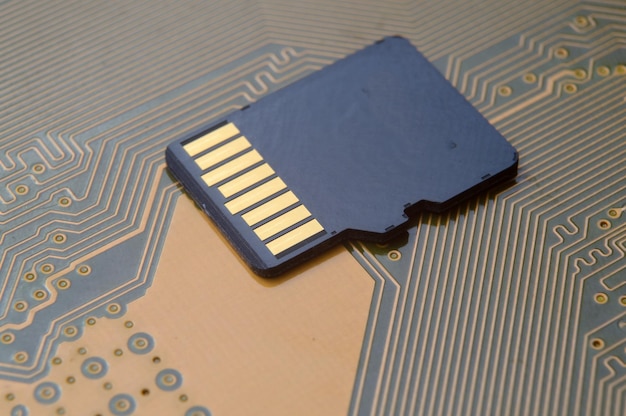 the black micro sd card lies on the microcircuit. close-up.