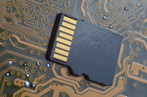 the black micro sd card lies on the microcircuit. close-up.