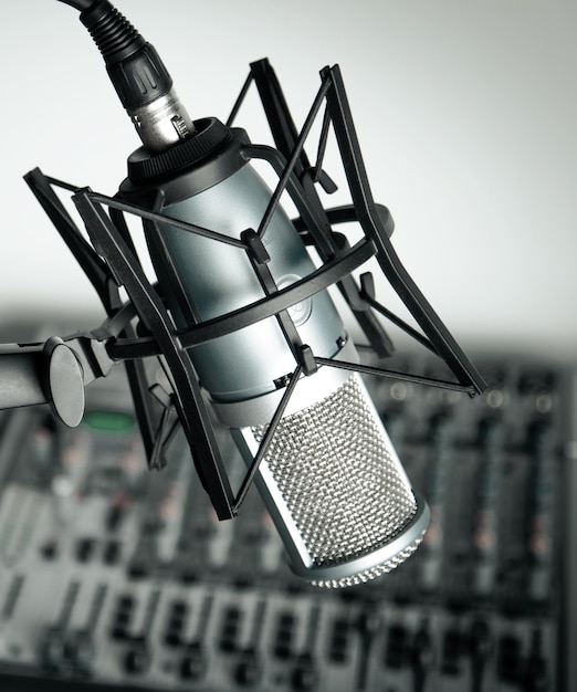 Black modern microphone on blurred background