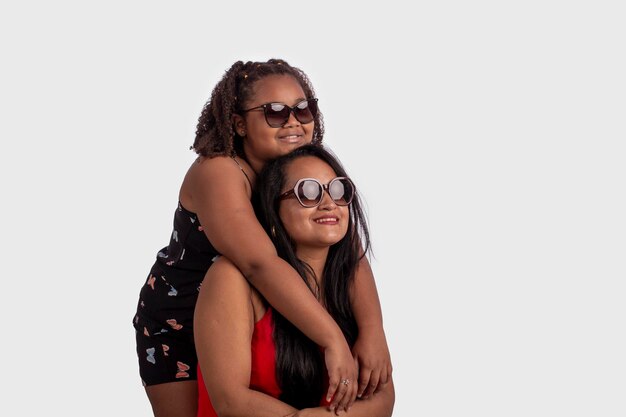 Black mother and daughter with afro hair in studio photo with white background for cropping