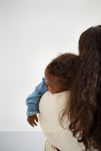 black mother taking car of her child