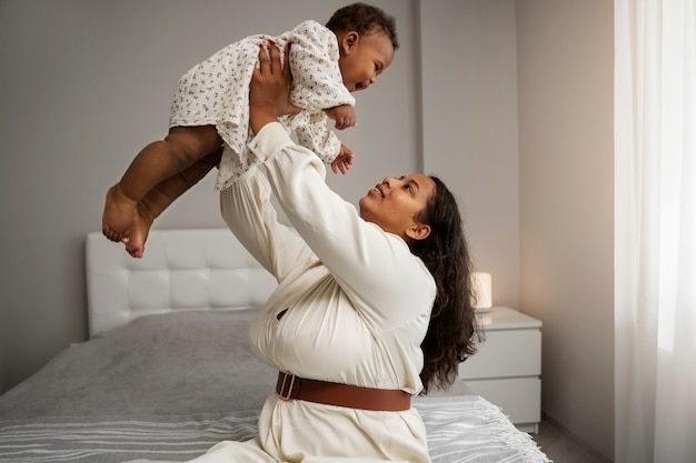 black mother taking car of her child