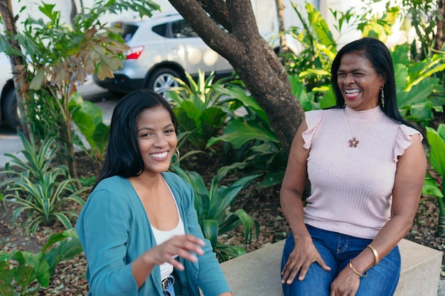 Black mother and teenage girl smiling at the camera