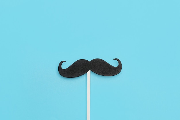 A black moustache on a blue background