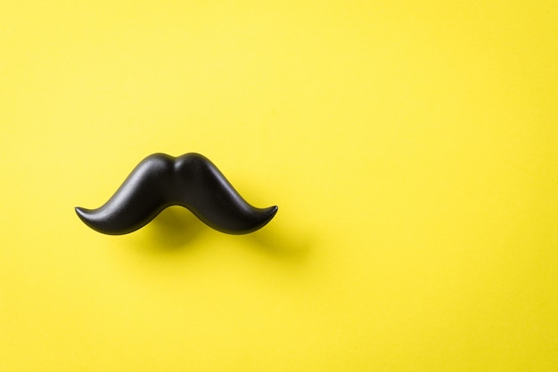 Black moustache on yellow paper